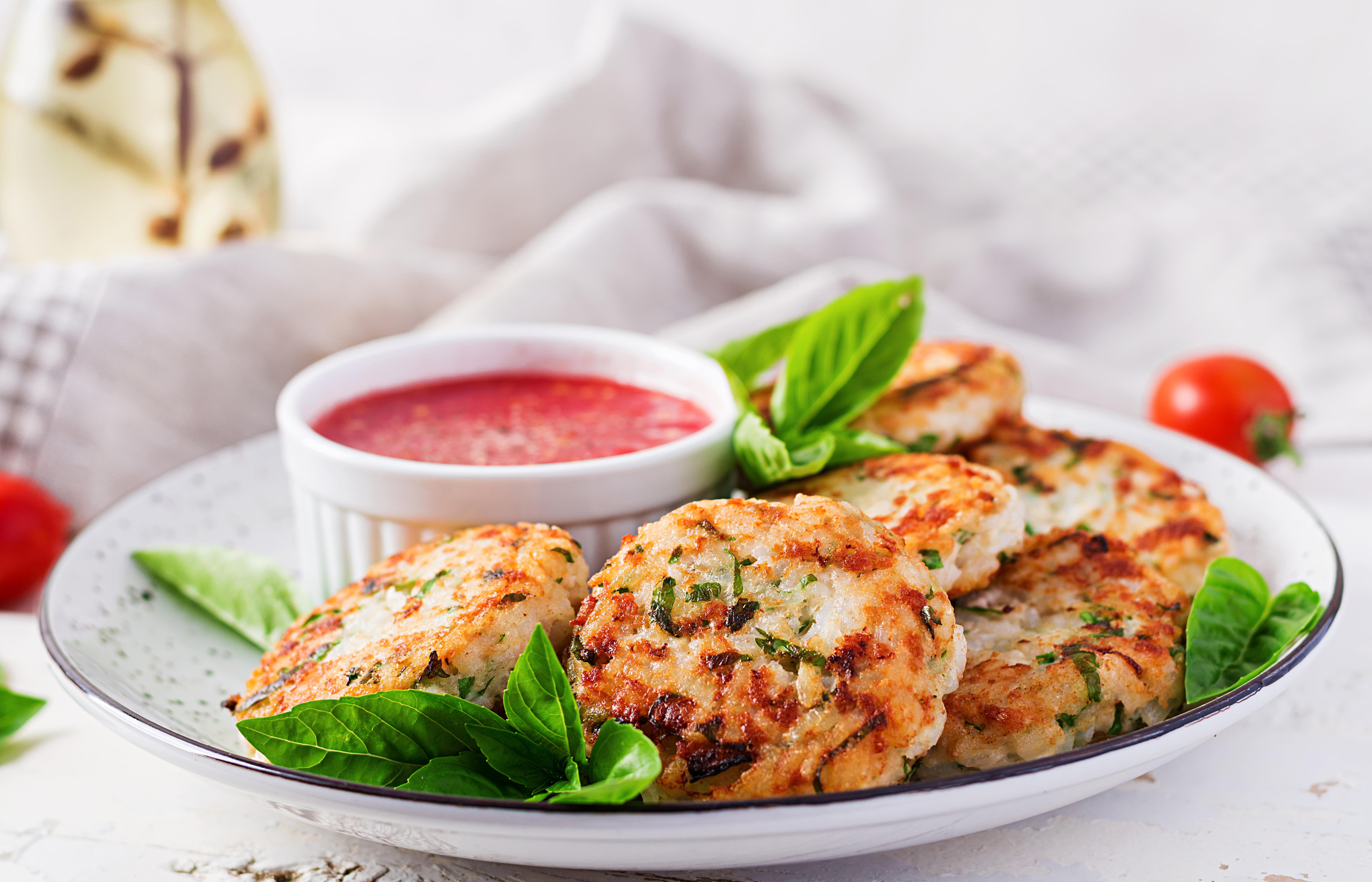 Delicious rice and chicken meat patties with garlic tomato sauce. Diet food.