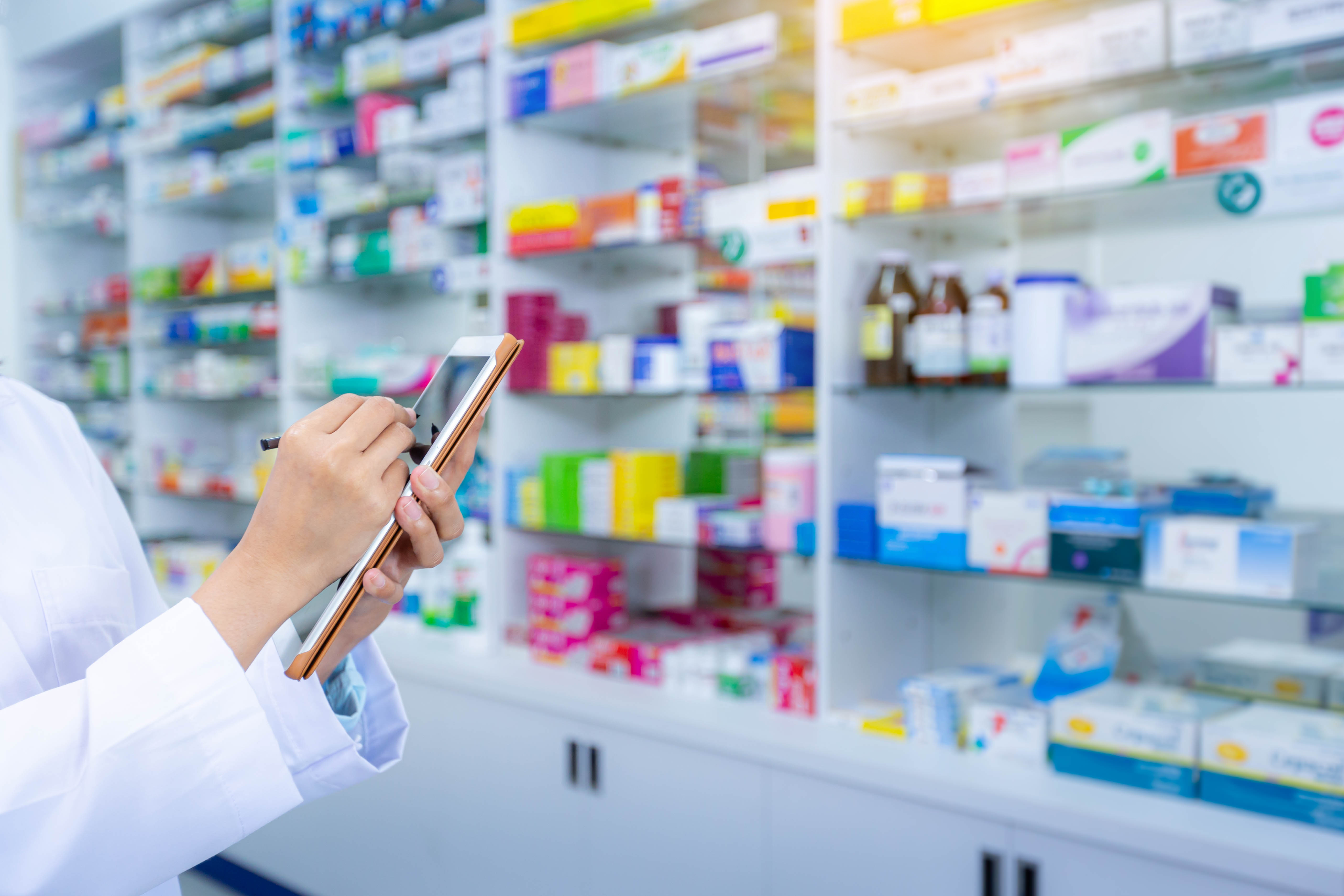 Hand female pharmacist using computer tablet for check prescription. Health care and medical concept.